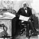 American orator, editor, author, abolitionist and former slave Frederick Douglass (1818 - 1895) edits a journal at his desk, late 1870s.